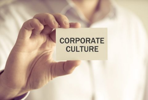 Businessman Holding Corporate Culture Message Card
